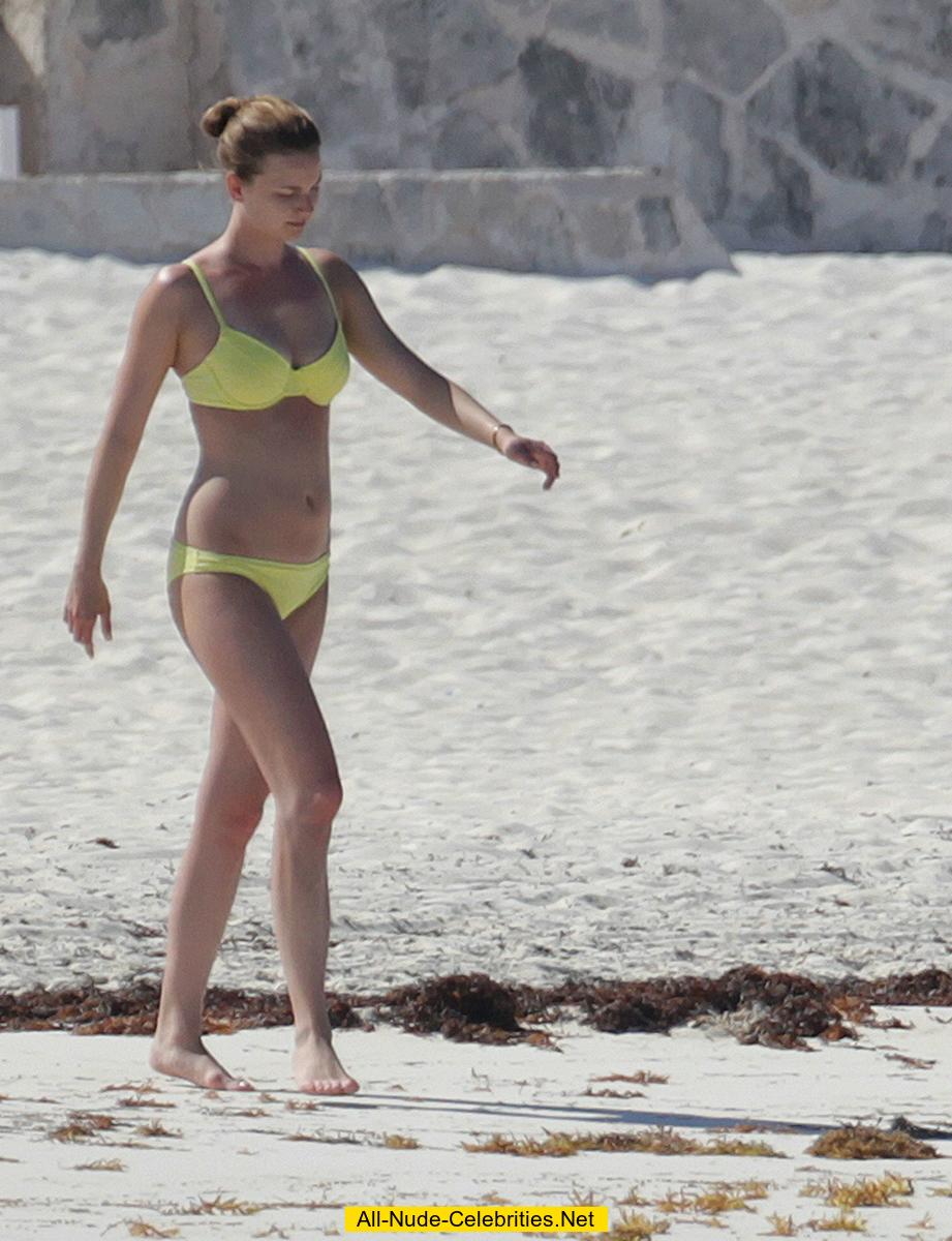 Emily VanCamp in yellow bikini on a beach