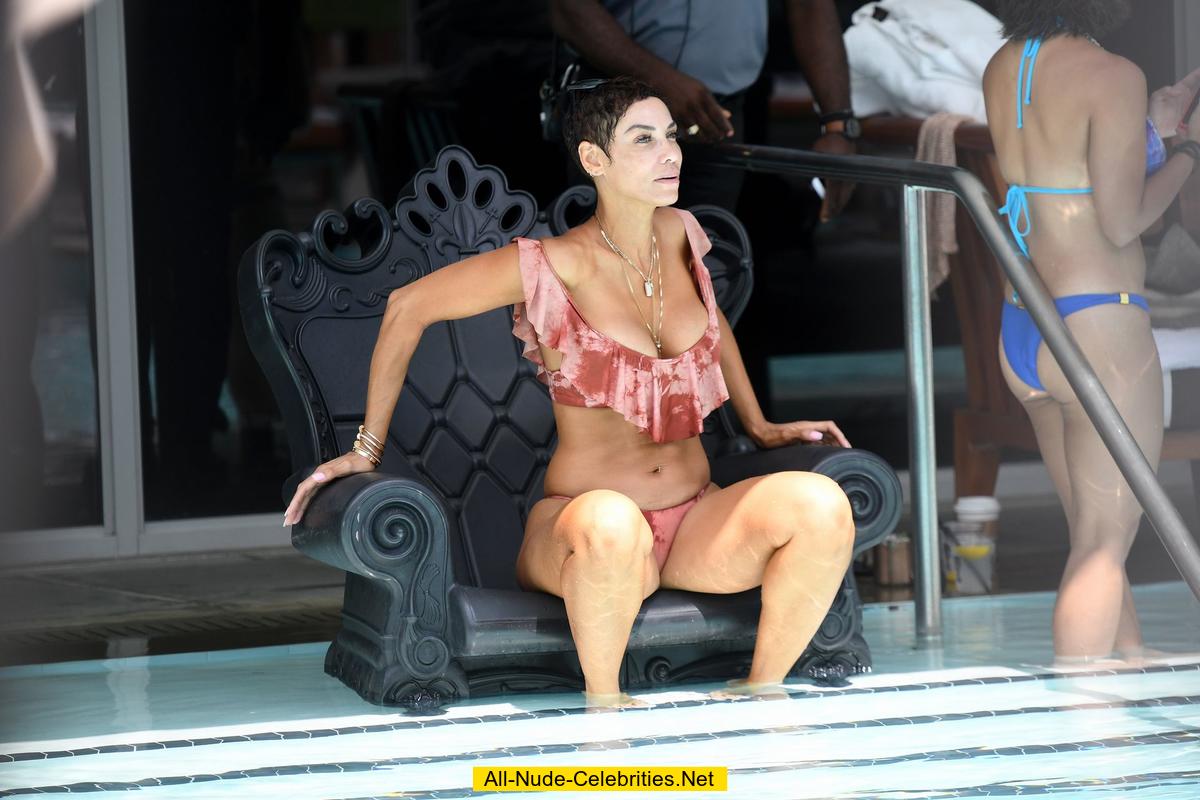 Nicole Murphy relaxing poolside in bikini